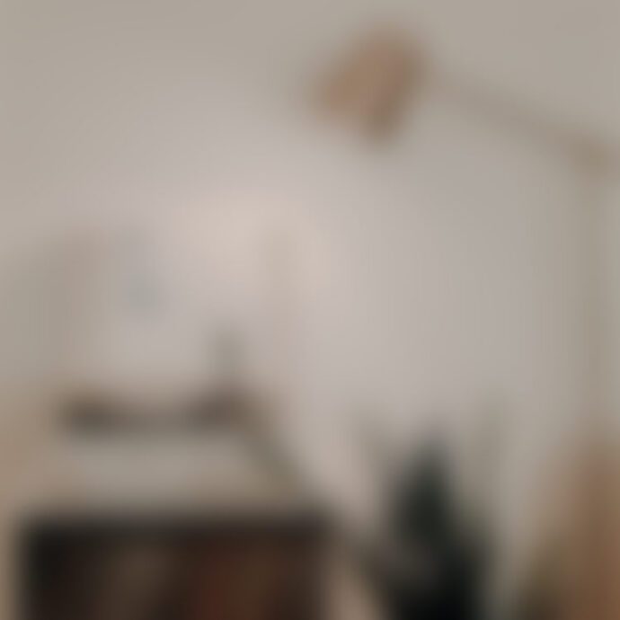 Blurry minimalist home office desk and lamp