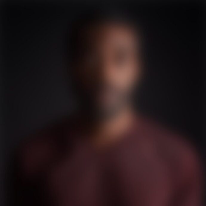 Blurred portrait of person against dark background