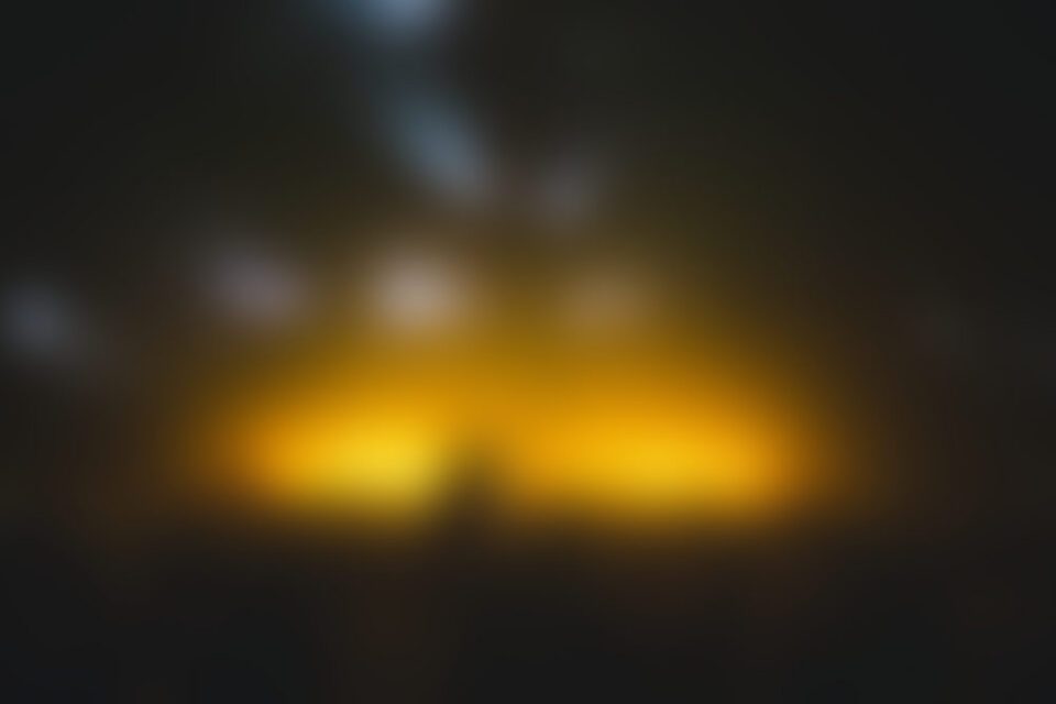 Blurred amber lights glowing in darkness
