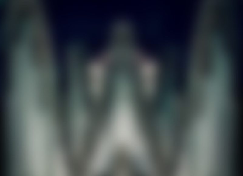 Blurred illuminated cathedral spires at night