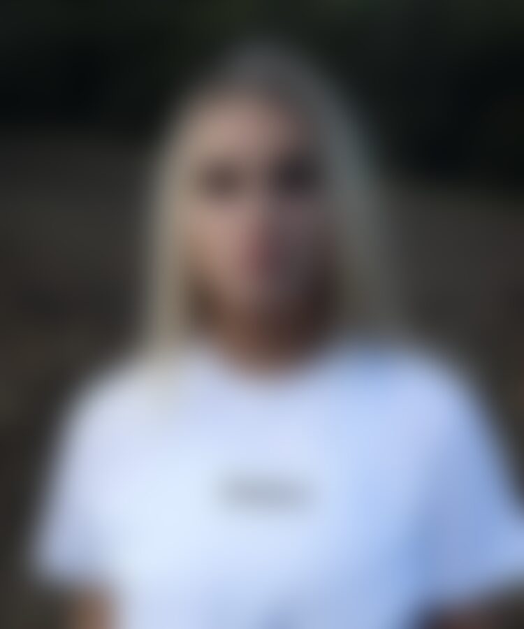 Blurred portrait of person wearing white shirt